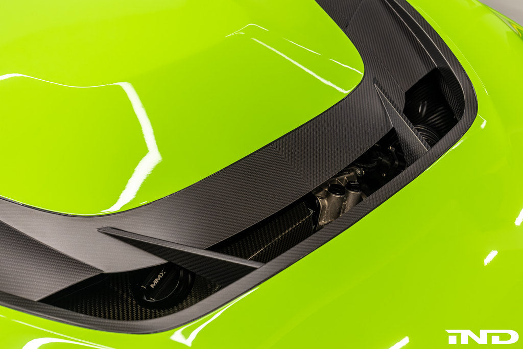 Alpha N F87 M2 Carbon Corse vented hood installed on a car, showcasing a sleek, lightweight exterior with vented design details.