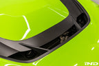 Alpha N F87 M2 Carbon Corse vented hood installed on a car, showcasing a sleek, lightweight exterior with vented design details.