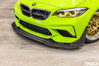 Alpha N F87 M2 Competition CS Carbon Corse front splitter installed on the exterior of a BMW M2, showcasing its aerodynamic design.