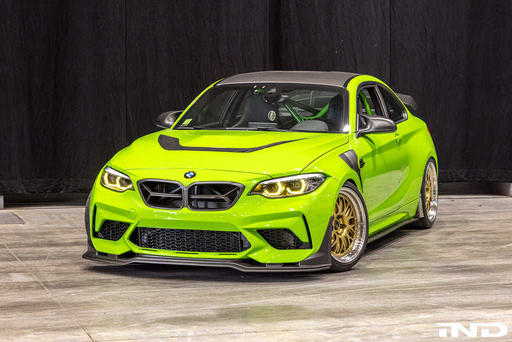 Alpha-N F87 M2 Competition front splitter installed on car, showcasing carbon Corse exterior upgrade for enhanced aerodynamics.