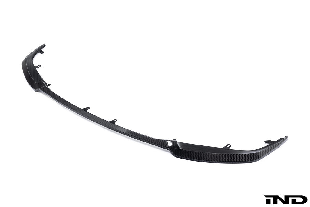 Alpha N G87 M2 Carbon GT front lip installed on a vehicle, showcasing its sleek white exterior design and aerodynamic style.