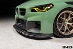 Alpha N G87 M2 Carbon Corse front splitter installed, matte clear exterior automotive part for enhanced aerodynamics.