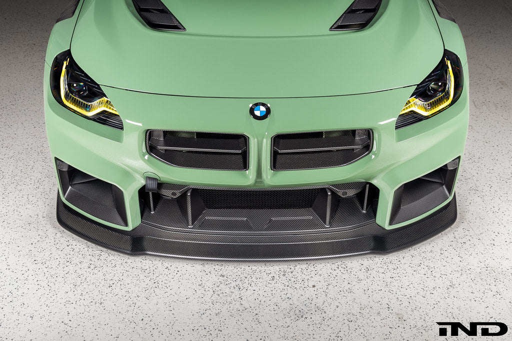 Alpha-N G87 M2 Carbon Corse front splitter installed, matte clear exterior car part for enhanced aerodynamics and style.