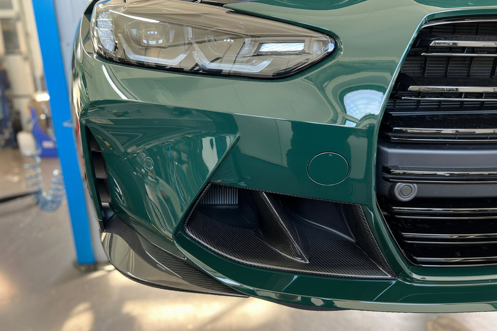 Alpha N G8X M3 M4 carbon front corner splitter set installed on vehicle's exterior for aerodynamic enhancement.