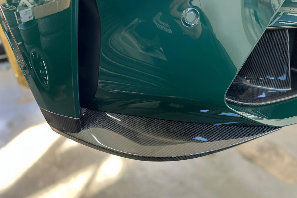 Alpha N G8X M3 M4 Carbon Front Corner Splitters installed on vehicle exterior, enhancing aerodynamics and sporty appearance.