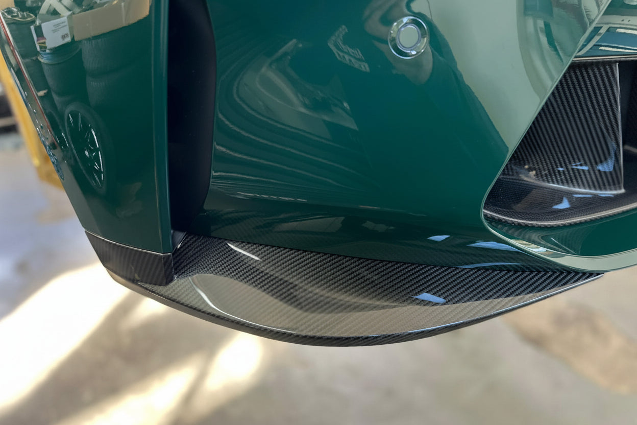 Alpha N G8X M3 M4 Carbon Front Corner Splitters installed on vehicle exterior, enhancing aerodynamics and sporty appearance.