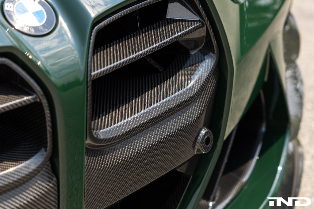 Alpha N G8X M3 M4 carbon front grille installed on vehicle, showcasing sleek exterior design and premium carbon fiber finish.