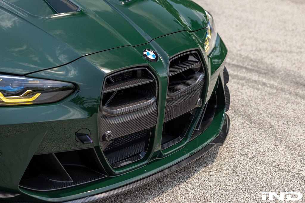 Alpha N G8X M3 M4 carbon front grille installed on vehicle exterior, showcasing sleek, lightweight design and premium carbon fiber finish.