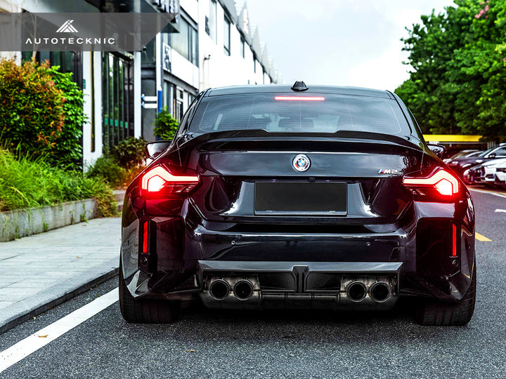 AutoTecknic BMW G87 M2 dry carbon rear diffuser installed on the exterior of the vehicle.