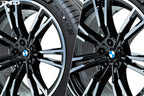 IND Gloss Black wheel center cap set for BMW, 56mm, installed on wheel with tire, displayed on white background.