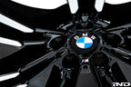 IND Gloss Black Wheel Center Cap Set for BMW, 56mm, installed on wheel with tire, on a white background.