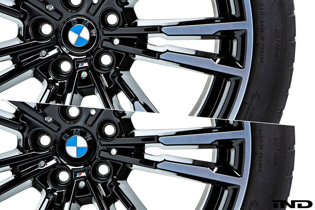 BMW wheels with IND gloss black 56mm wheel center caps installed on white background