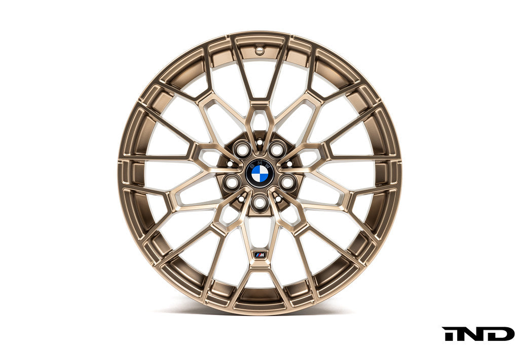 BMW 56mm wheel center cap set Next Dark design installed on BMW 827M gold wheels with white background