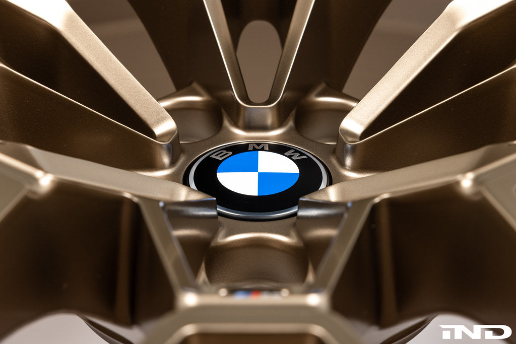 BMW 56mm wheel center cap set Next Dark design installed on BMW 827M gold wheels with white background