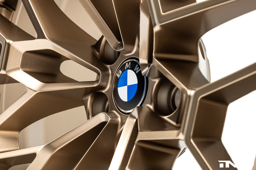 BMW 56mm wheel center cap set Next Dark design installed on BMW 827M gold wheels with white background