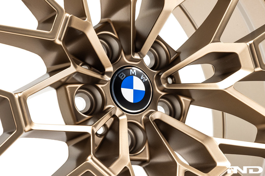 BMW 56mm wheel center cap set Next Dark design installed on BMW 827M gold wheels with white background