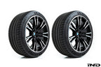 BMW wheels with 56mm center caps installed showing IND gloss black center cap compared to factory chrome center cap on white background