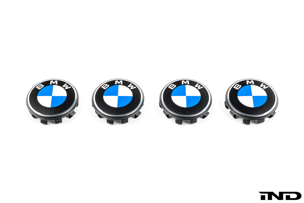 BMW 56mm wheel center caps Next Dark design genuine BMW center caps on white background