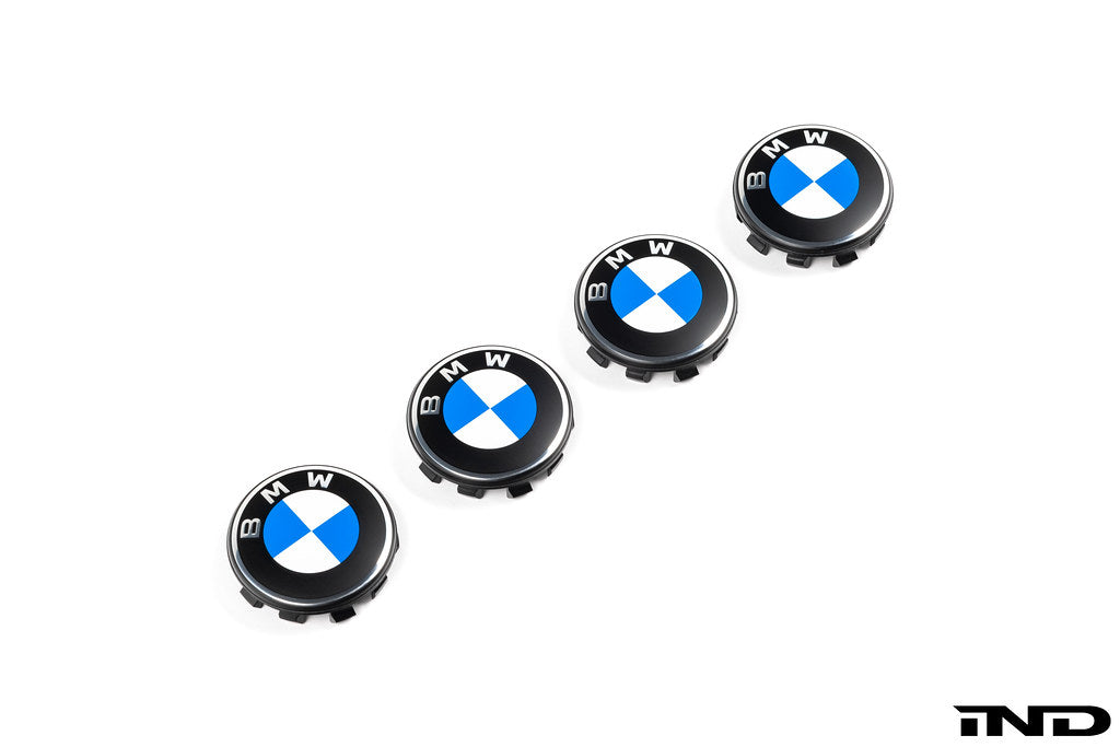 BMW 56mm wheel center caps Next Dark design genuine BMW center caps on white background