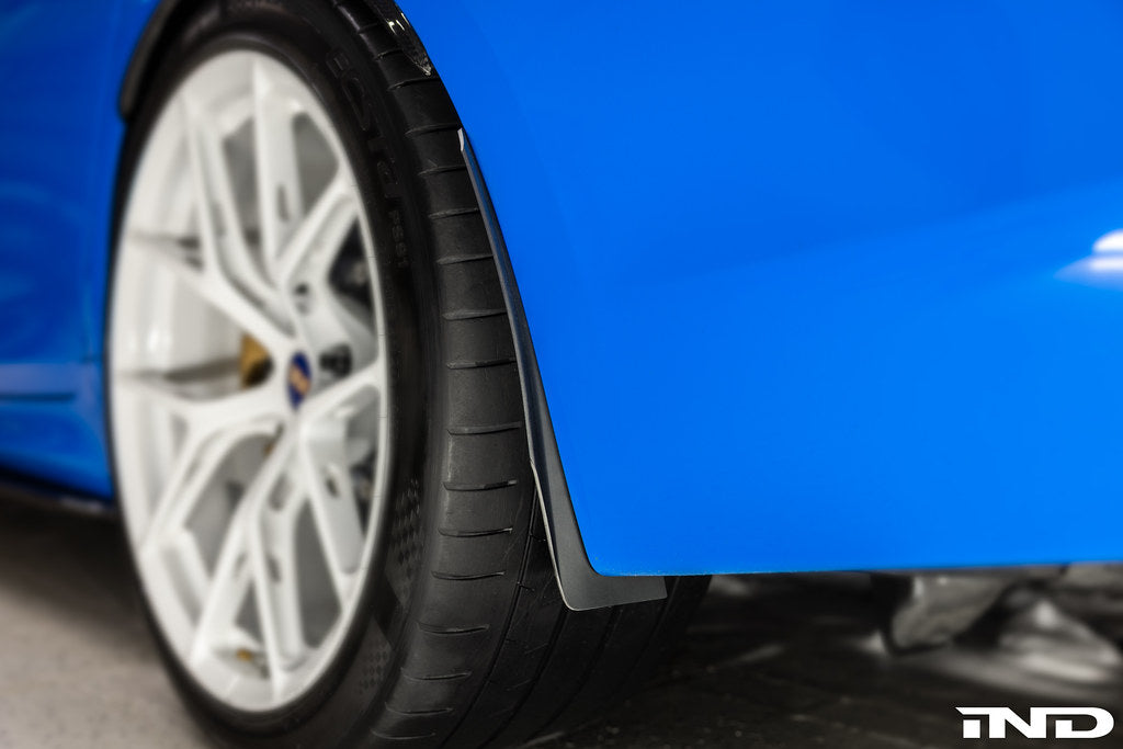 Blue Megachip F90 M5 splash guard set installed on BMW F90 M5 exterior, showing protective guards on wheel arches.