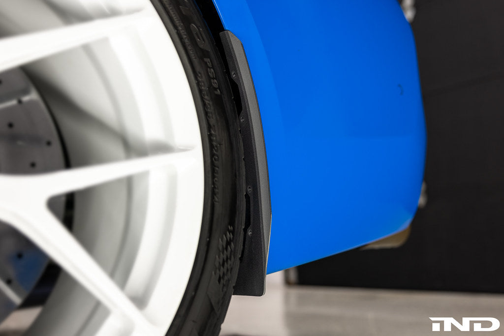 Blue Megachip F90 M5 splash guard set installed on BMW F90 M5 exterior, showing the protective mud flaps in detail.