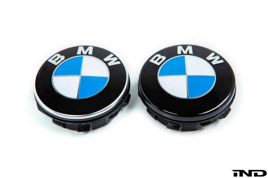 Genuine BMW chrome-edge floating center cap next to IND Gloss Black floating center cap