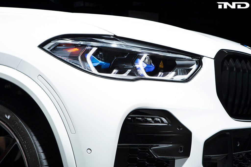 IND Painted Front Reflector Set installed on a BMW G05 X5 and F95 X5M, replacing the factory amber front bumper reflectors with color-matched painted reflectors.