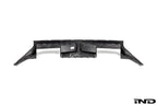 BMW G87 M2 CS carbon rear diffuser, exterior car part with aerodynamic design and black carbon fiber finish.