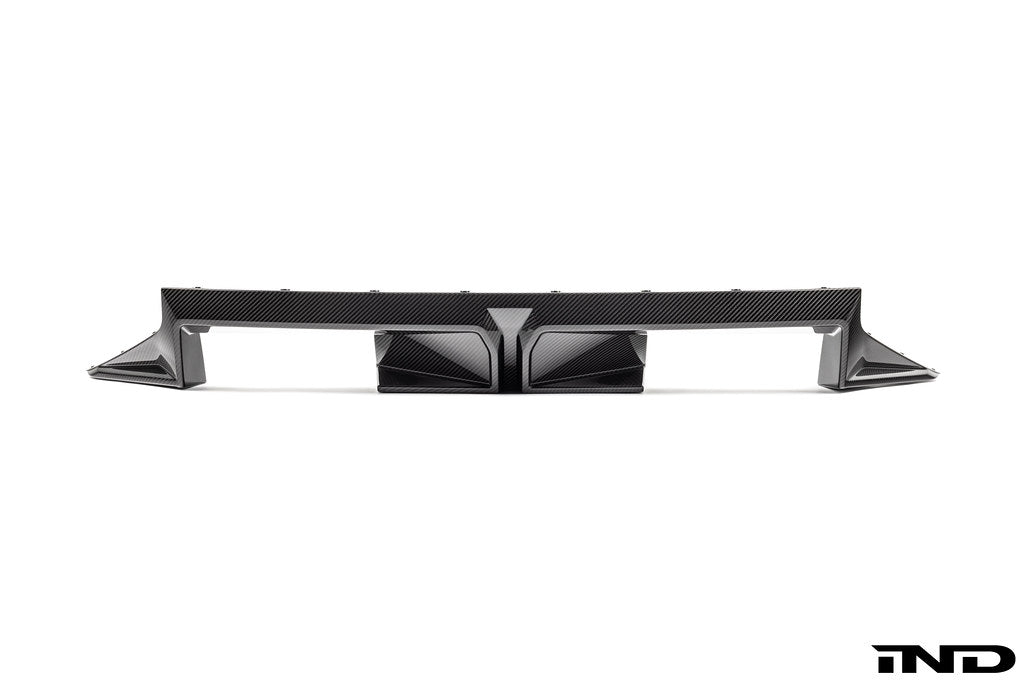 BMW G87 M2 CS exterior carbon rear diffuser showing sleek black carbon fiber design and aerodynamic detailing.