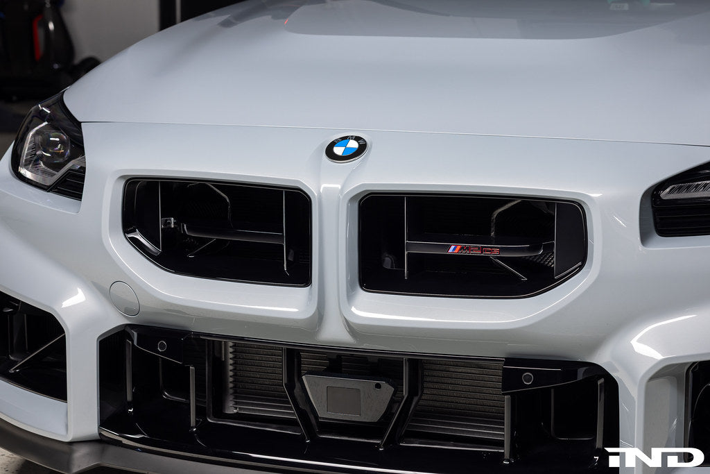 BMW G87 M2 CS front grille emblem installed on the exterior of the vehicle, showcasing the BMW logo on the grille.