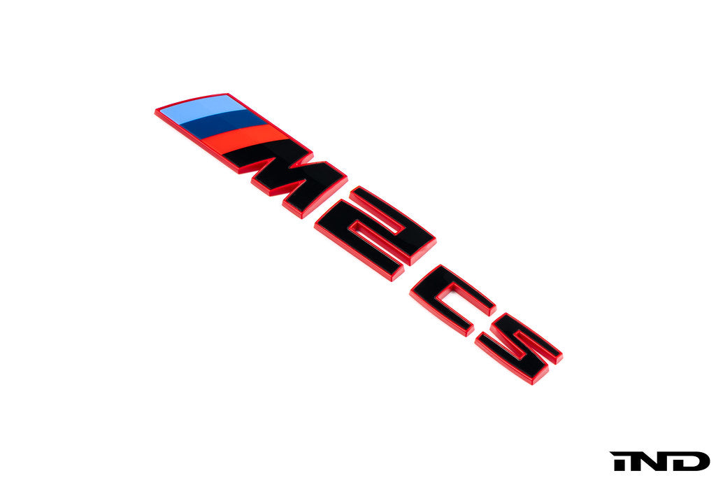 BMW G87 M2 CS trunk emblem in gloss black with red border on a white background, exterior car badge for BMW M2 CS.