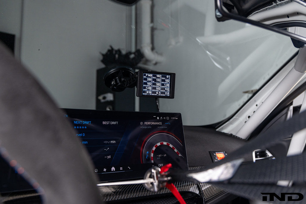 CANchecked MFD32 Multi Function Universal Display Gen2 installed inside BMW G87 M2 Racing showing integrated 3.2-inch motorsport data display mounted within the factory interior cockpit.
