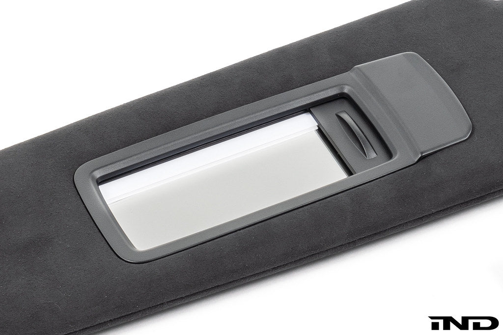 BMW G90 G99 M5 Alcantara European sun visor mirror shade open
 shown on a white background
