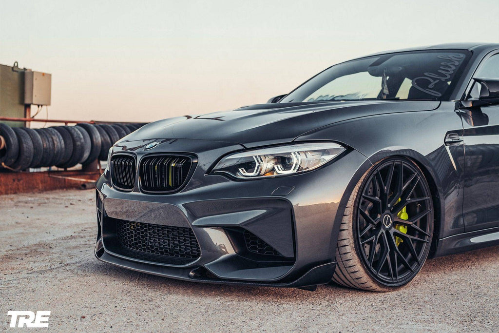 TREVORA BMW F87 M2 OG Pre-Preg Carbon Fiber Front Splitter installed on exterior of 2015-2018 BMW M2.