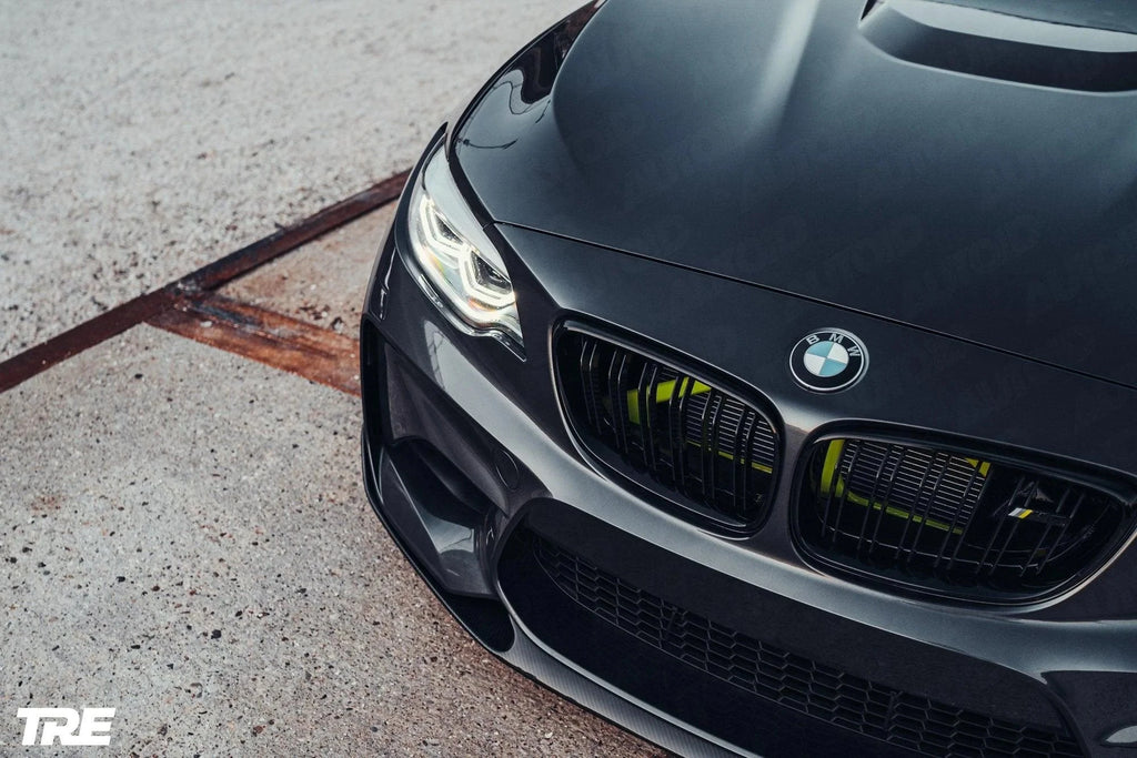 TREVORA BMW F87 M2 OG pre-preg carbon fiber front splitter installed on 2015-2018 BMW M2, enhancing aerodynamics and sporty appearance.