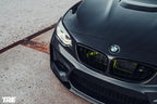 TREVORA BMW F87 M2 OG pre-preg carbon fiber front splitter installed on 2015-2018 BMW M2, enhancing aerodynamics and sporty appearance.