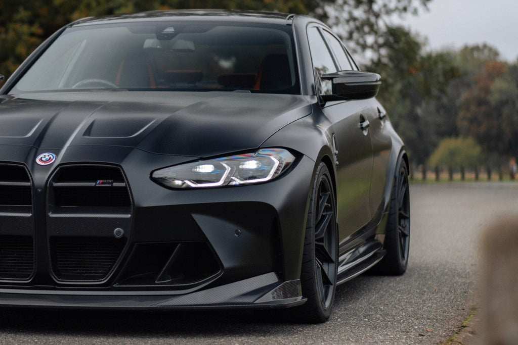 BMW M3 G80 side skirts made of pre-preg carbon fiber by TREVORA, showcasing their sleek exterior design and lightweight construction.