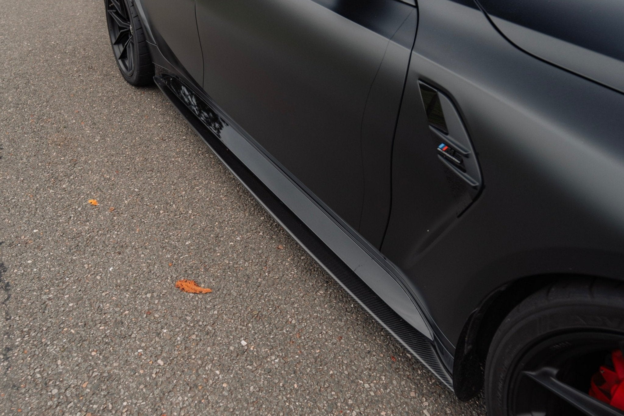 BMW M3 G80 side skirts made of TREVORA G80 M3 Pre-Preg Carbon Fiber PR-1 exterior upgrade, showcasing sleek carbon fiber finish.