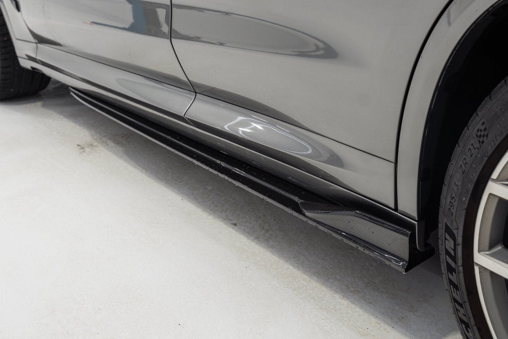 TREVORA BMW F97 X3M and F98 X4M carbon fiber side skirt set installed on exterior of 2019-2021 models.