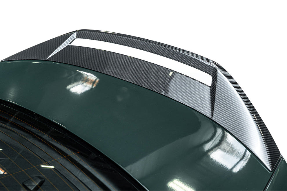 ADRO G80 M3 carbon fiber trunk spoiler mounted on a BMW G80 M3 exterior view, showcasing lightweight aerodynamic design.