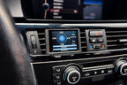 CANchecked E9X M3 3-Series Multi Function Display installed in interior, showing 2.8-inch Gen2 LCD screen on LHD BMW E92 M3.