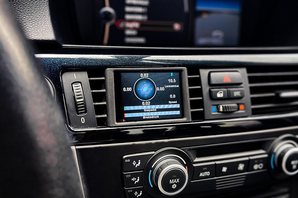 CANchecked E9X M3 3-Series Multi Function Display installed in interior, showing 2.8-inch Gen2 LCD screen on LHD BMW E92 M3.