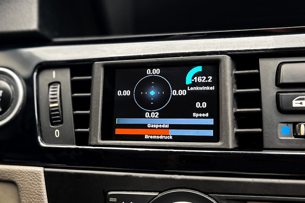 CANchecked E9X M3 3-Series multi-function display installed inside a BMW E92 M3 interior, 2.8-inch Gen2 LHD dashboard upgrade