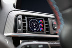 CANchecked F8X/F3X/F22 2.8" Gen2 multi-function display installed in BMW M2 F87 interior, showing digital gauges and controls.