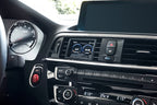 CANchecked F8X/F3X/F22 2.8" Gen2 multi-function display installed in BMW F87 M2 interior, showing digital readouts.