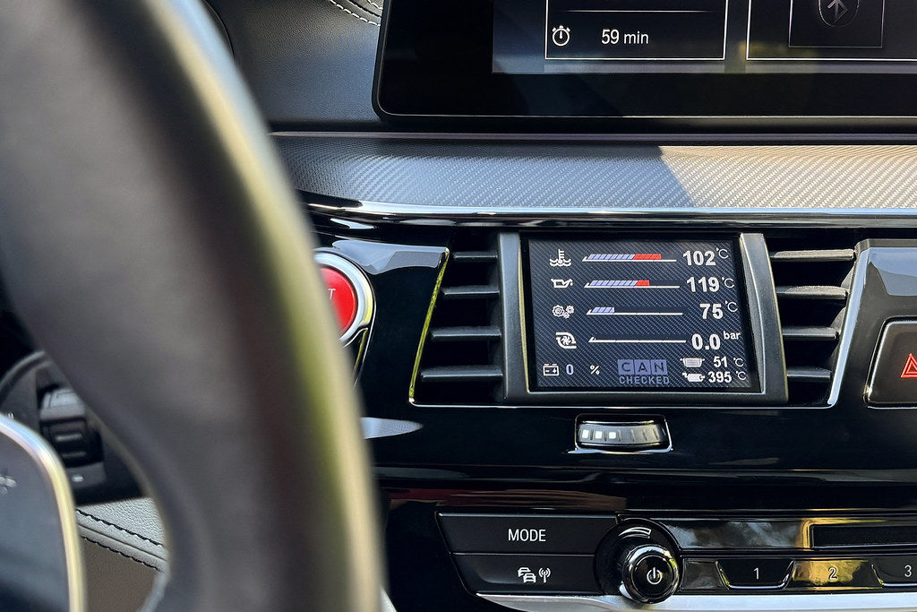CANchecked F90 M5 G30 5-Series interior multi-function display installed in BMW, showing 3.2-inch Gen2 screen on dashboard.