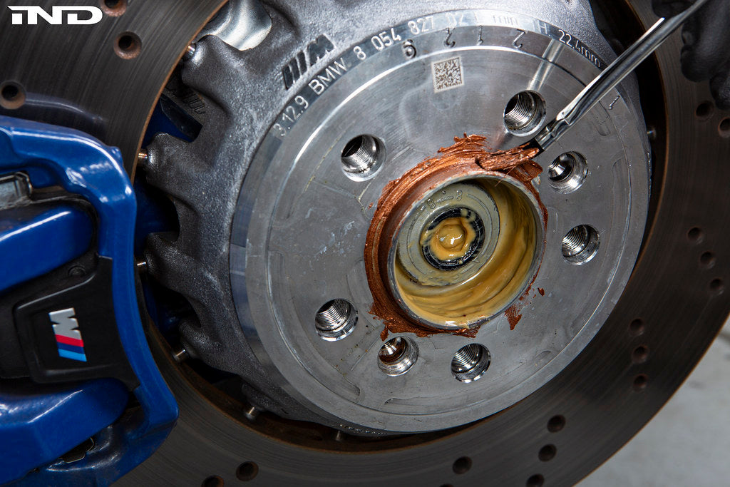 FC BMW and Supra 5x112 wheel spacer kit with copper anti-seize applied to hub and spacer for secure installation.