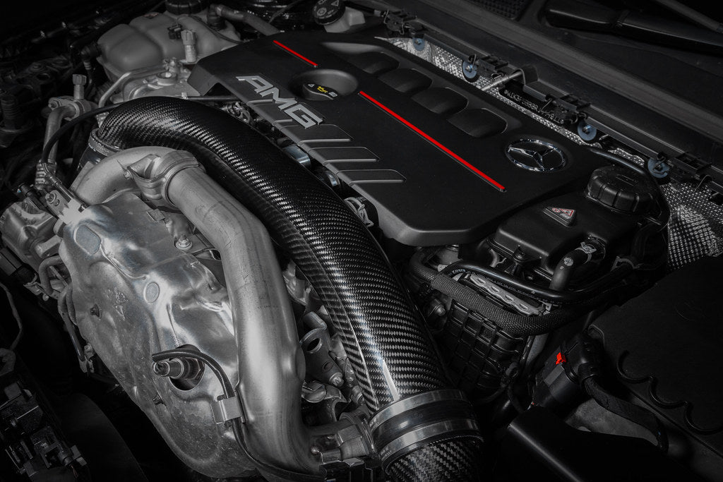 Eventuri black carbon hybrid turbo tube installed in a Mercedes AMG A35 / CLA35, showcasing performance upgrade components.