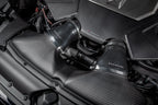 Eventuri black carbon intake system installed in the engine bay of Audi C8 RS6 and RS7 performance vehicles.