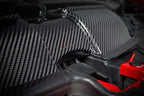 Eventuri gloss carbon fiber duct set installed in the engine bay of a red BMW E92 M3 Coupe